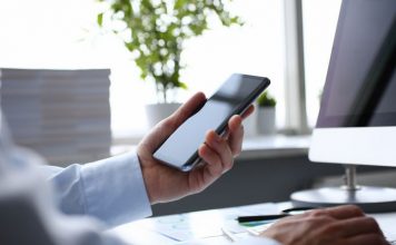Businessman hipster holds telephone background