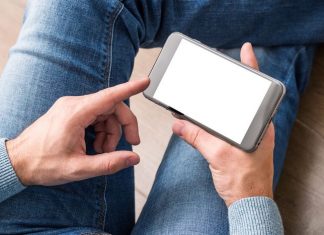 Smartphone in man's hands. Clipping path included.