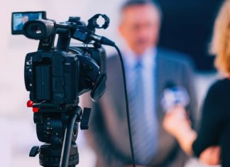 Interview. Journalist interviewing businessman